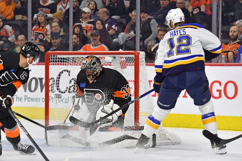 Mar 4, 2024; Philadelphia, Pennsylvania, USA; Philadelphia Flyers goaltender Samuel Ersson (33) makes a save against St. Louis Blues right wing Kevin Hayes (12) during the first period at Wells Fargo Center. Mandatory Credit: Eric Hartline-USA TODAY Sports