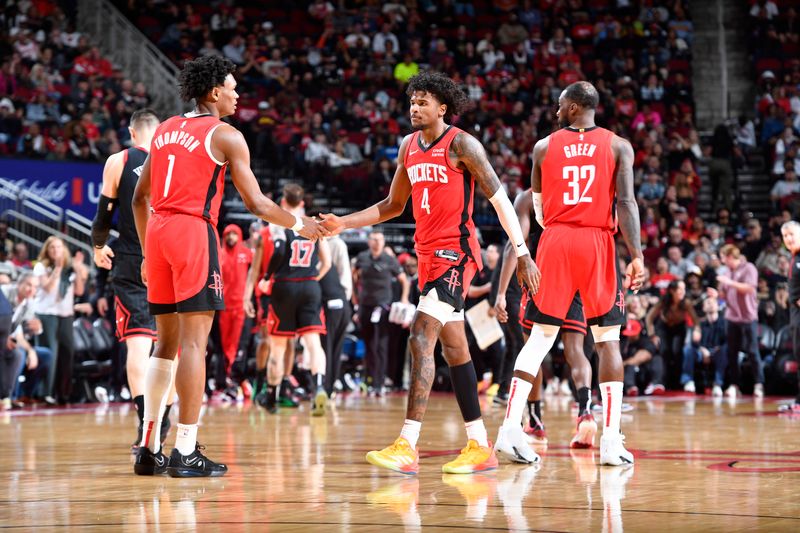 HOUSTON, TX - MARCH 21:   Jalen Green #4 and Amen Thompson #1 of the Houston Rockets react during the game against the Chicago Bulls on March 21, 2024 at the Toyota Center in Houston, Texas. NOTE TO USER: User expressly acknowledges and agrees that, by downloading and or using this photograph, User is consenting to the terms and conditions of the Getty Images License Agreement. Mandatory Copyright Notice: Copyright 2024 NBAE (Photo by Logan Riely/NBAE via Getty Images)