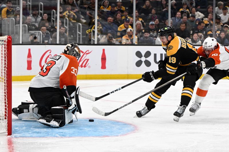 Oct 1, 2024; Boston, Massachusetts, USA; Boston Bruins center John Beecher (19) attempts a shot against Philadelphia Flyers goaltender Samuel Ersson (33) during the third period at the TD Garden. Mandatory Credit: Brian Fluharty-Imagn Images