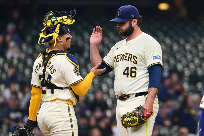 Apr 17, 2024; Milwaukee, Wisconsin, USA;  Milwaukee Brewers pitcher Bryse Wilson (46) exchange handshakes with catcher William Contreras (24) during a pitching change in the fourth inning against the San Diego Padres at American Family Field. Mandatory Credit: Benny Sieu-USA TODAY Sports