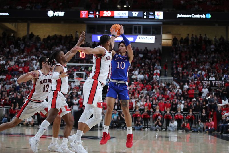 Jan 3, 2023; Lubbock, Texas, USA;  Kansas Jayhawks forward Jalen Wilson (10) takes a three-point shot over Texas Tech Red Raiders forward Kevin Obanor (0) in the first half at United Supermarkets Arena. Mandatory Credit: Michael C. Johnson-USA TODAY Sports