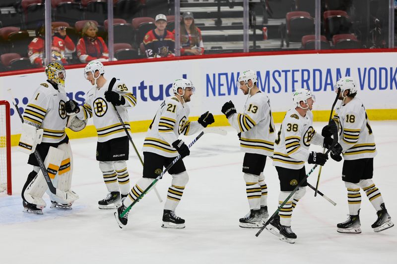 May 6, 2024; Sunrise, Florida, USA; Boston Bruins players celebrate with goaltender Jeremy Swayman (1) after defeating the Florida Panthers in game one of the second round of the 2024 Stanley Cup Playoffs at Amerant Bank Arena. Mandatory Credit: Sam Navarro-USA TODAY Sports