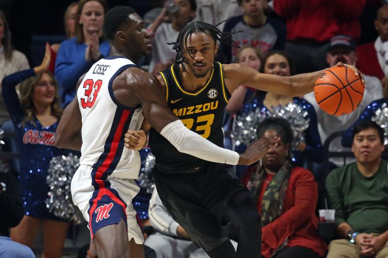 Feb 17, 2024; Oxford, Mississippi, USA; Missouri Tigers forward Aidan Shaw (23) handles the ball as Mississippi Rebels forward Moussa Cisse (33) defends during the second half at The Sandy and John Black Pavilion at Ole Miss. Mandatory Credit: Petre Thomas-USA TODAY Sports