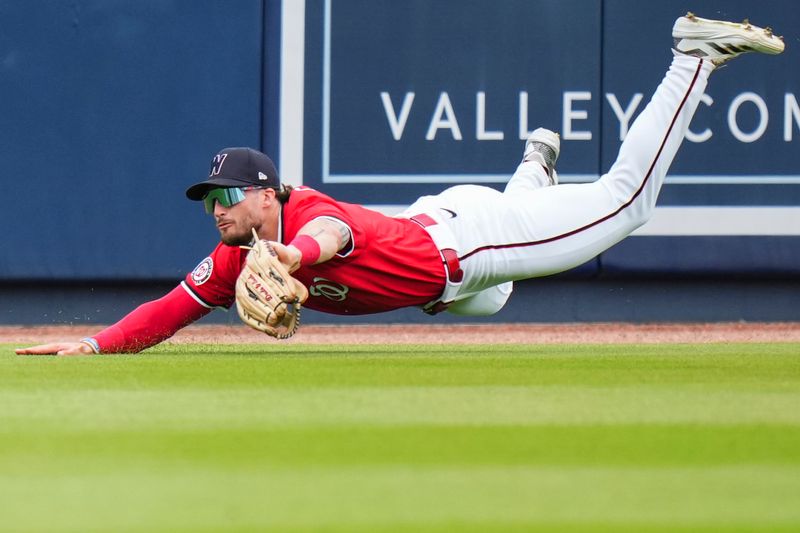 Mar 4, 2025; West Palm Beach, Florida, USA; Washington Nationals outfielder Dylan Crews (3) catches a fly ball for an out against the St. Louis Cardinals during the second inning at CACTI Park of the Palm Beaches. Mandatory Credit: Rich Storry-Imagn Images