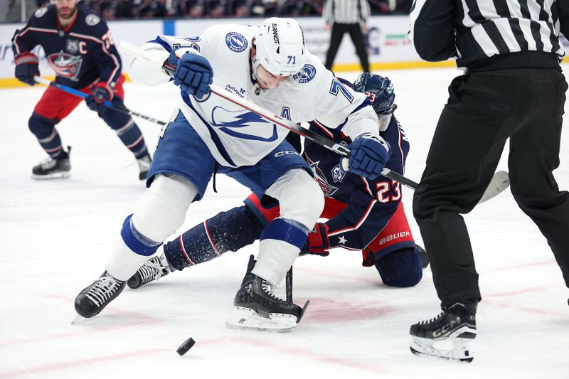 Jan 24, 2026; Columbus, Ohio, USA;  Columbus Blue Jackets center Sean Monahan (23) battle for the puck as he faces off with Tampa Bay Lightning center Anthony Cirelli (71) during the second period at Nationwide Arena. Mandatory Credit: Joseph Maiorana-Imagn Images