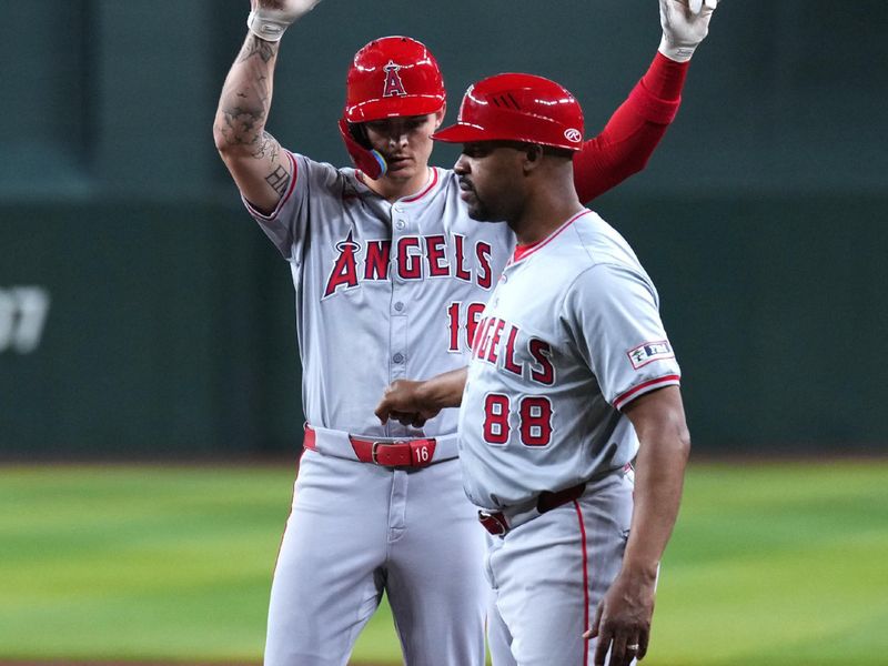 Jun 13, 2024; Phoenix, Arizona, USA; Los Angeles Angels outfielder Mickey Moniak (16) celebrates with Los Angeles Angels first base coach Bo Porter (88) after hitting an RBI single against the Arizona Diamondbacks during the third inning at Chase Field. Mandatory Credit: Joe Camporeale-USA TODAY Sports