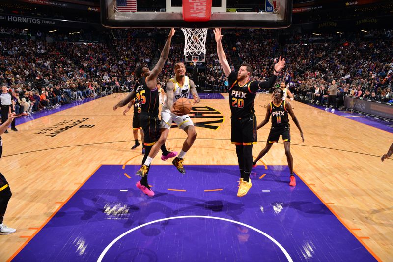 PHOENIX, AZ - FEBRUARY 8: John Collins #20 of the Utah Jazz drives to the basket during the game against the Phoenix Suns on February 8, 2024 at Footprint Center in Phoenix, Arizona. NOTE TO USER: User expressly acknowledges and agrees that, by downloading and or using this photograph, user is consenting to the terms and conditions of the Getty Images License Agreement. Mandatory Copyright Notice: Copyright 2024 NBAE (Photo by Barry Gossage/NBAE via Getty Images)