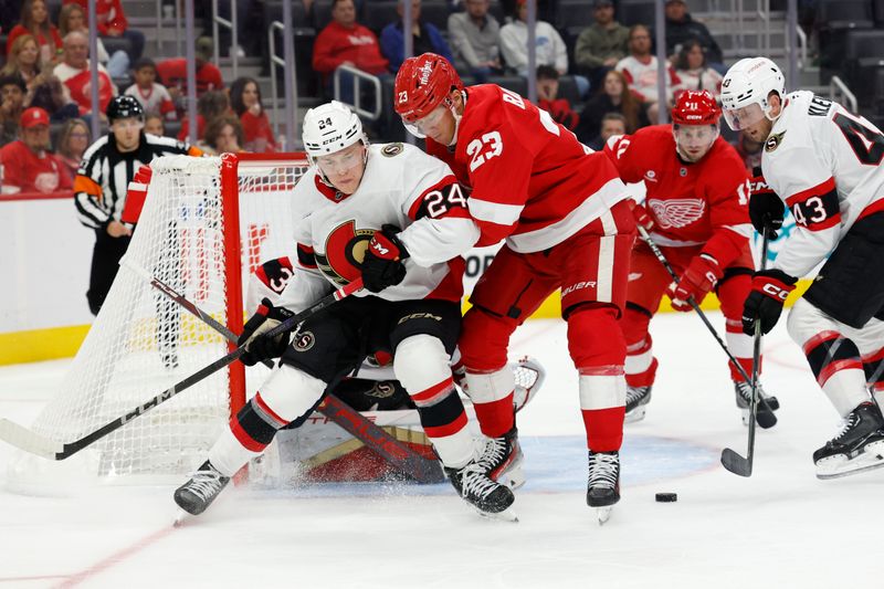 Oct 4, 2024; Detroit, Michigan, USA;  Ottawa Senators defenseman Jacob Bernard-Docker (24) and Detroit Red Wings left wing Lucas Raymond (23) battle for the puck in the second period at Little Caesars Arena. Mandatory Credit: Rick Osentoski-Imagn Images