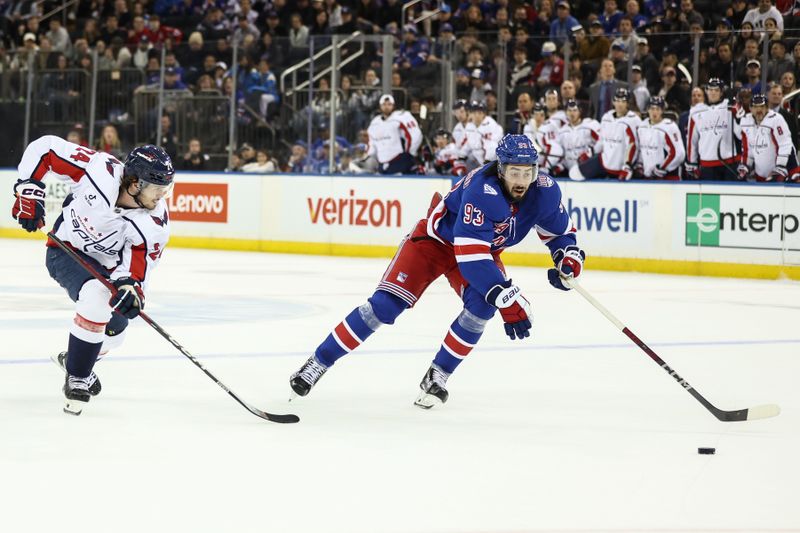 Oct 12, 2025; New York, New York, USA;  Washington Capitals center Connor McMichael (24) and New York Rangers center Mika Zibanejad (93) chase the puck in the third period at Madison Square Garden. Mandatory Credit: Wendell Cruz-Imagn Images