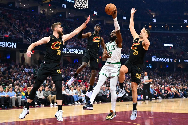 CLEVELAND, OHIO - MARCH 05: Dean Wade #32, Caris LeVert #3 and Georges Niang #20 of the Cleveland Cavaliers guard Jaylen Brown #7 of the Boston Celtics during the second quarter at Rocket Mortgage Fieldhouse on March 05, 2024 in Cleveland, Ohio. NOTE TO USER: User expressly acknowledges and agrees that, by downloading and or using this photograph, User is consenting to the terms and conditions of the Getty Images License Agreement. (Photo by Jason Miller/Getty Images)