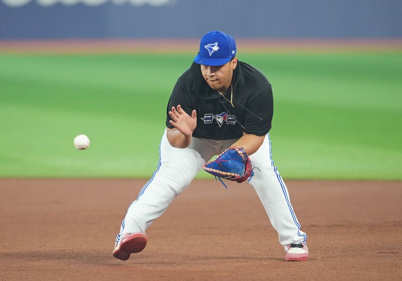 Jun 28, 2023; Toronto, Ontario, CAN; Victor Martinez, Jr fields balls during batting practice before a game between the San Francisco Giants and the Toronto Blue Jays at Rogers Centre. Mandatory Credit: Nick Turchiaro-USA TODAY Sports