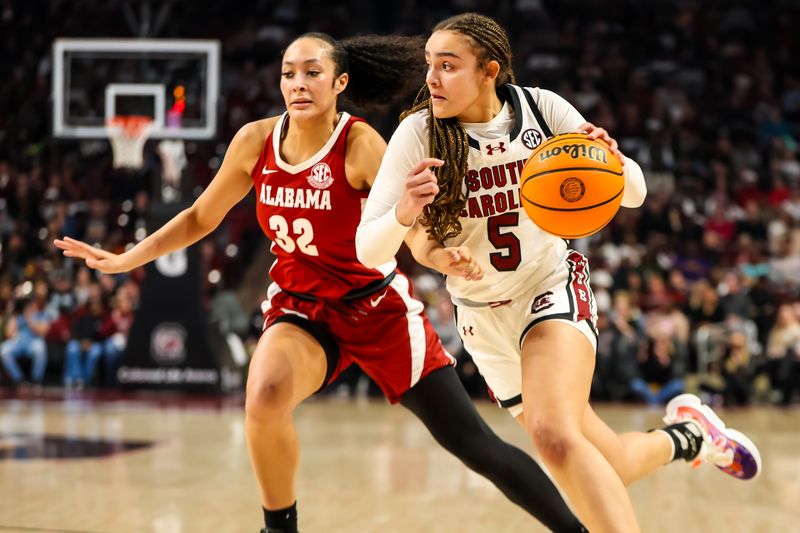 Feb 22, 2024; Columbia, South Carolina, USA; South Carolina Gamecocks guard Tessa Johnson (5) drives around Alabama Crimson Tide guard Aaliyah Nye (32) in the first half at Colonial Life Arena. Mandatory Credit: Jeff Blake-USA TODAY Sports