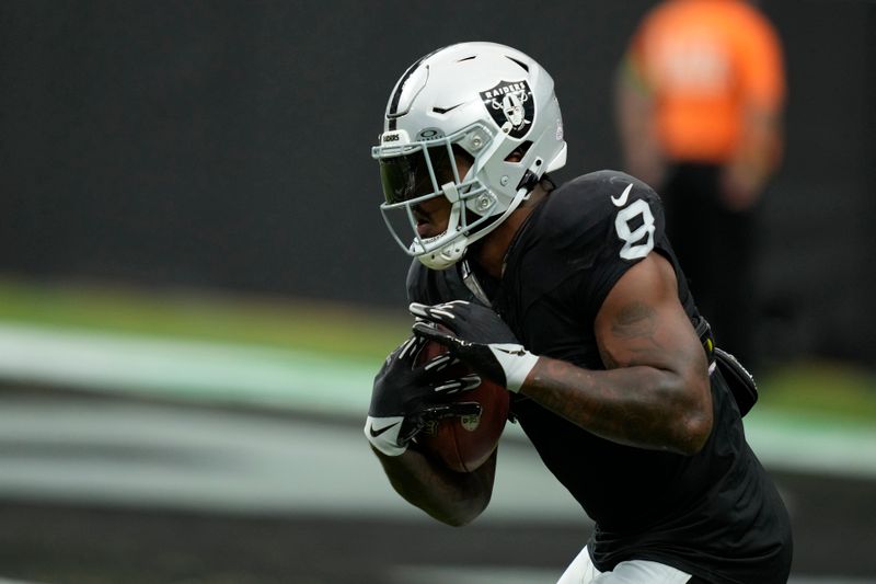 Las Vegas Raiders running back Josh Jacobs (8) warms up before an NFL football game against the New England Patriots, Sunday, Oct. 15, 2023, in Las Vegas. (AP Photo/John Locher)