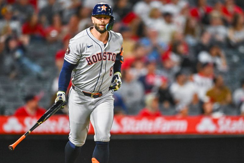 Sep 27, 2025; Anaheim, California, USA; Houston Astros first baseman Christian Walker (8) tosses his bat after hitting a solo home run against the Los Angeles Angels during the ninth inning at Angel Stadium. Mandatory Credit: Jonathan Hui-Imagn Images