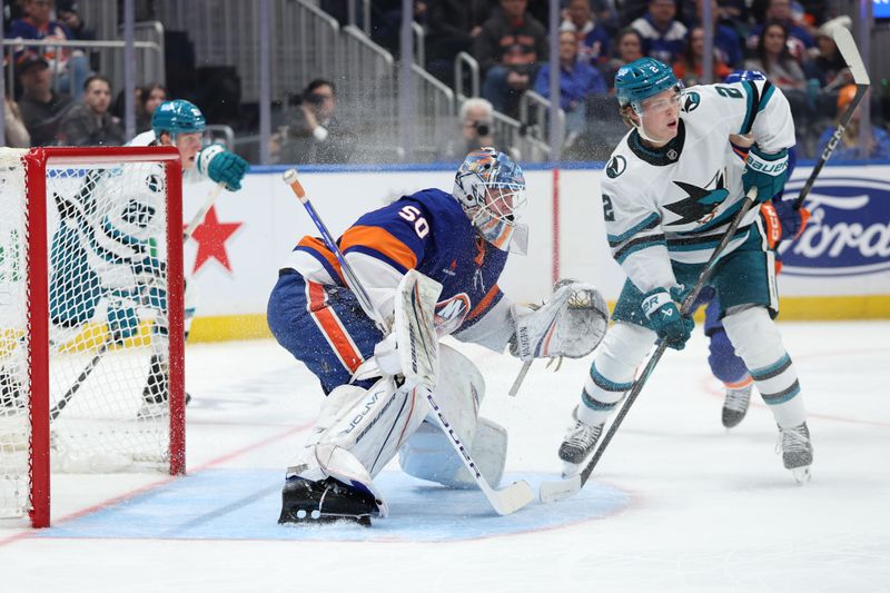 Jan 18, 2025; Elmont, New York, USA;  New York Islanders goaltender Marcus Hogberg (50) tracks the puck against the San Jose Sharks during the third period at UBS Arena. Mandatory Credit: Thomas Salus-Imagn Images