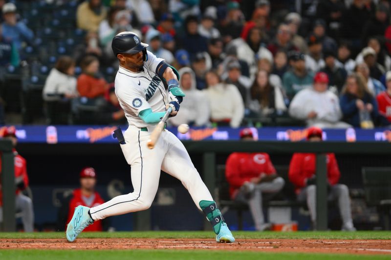 Apr 16, 2024; Seattle, Washington, USA; Seattle Mariners center fielder Julio Rodríguez (44) hits a single against the Cincinnati Reds during the fifth inning at T-Mobile Park. Mandatory Credit: Steven Bisig-USA TODAY Sports