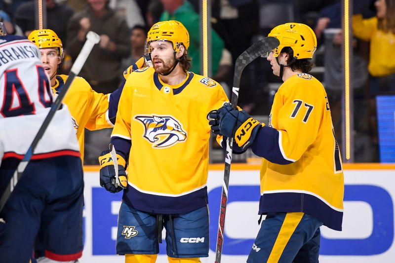 Apr 13, 2024; Nashville, Tennessee, USA; Nashville Predators center Tommy Novak (82) celebrates his goal against the Columbus Blue Jackets during the first period at Bridgestone Arena. Mandatory Credit: Steve Roberts-USA TODAY Sports