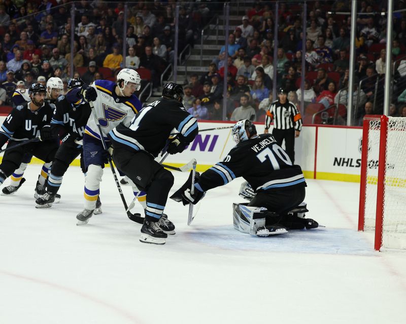 Sep 22, 2024; Des Moines, Iowa, USA;  Utah Hockey Club goaltender Karel Vejmelka (70) makes a save against the St. Louis Blues at Wells Fargo Arena. Mandatory Credit: Reese Strickland-Imagn Images

