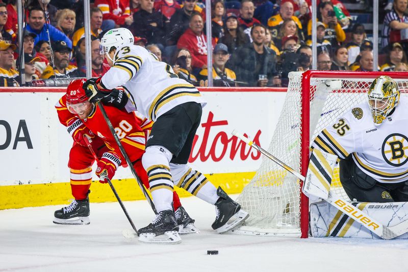 Feb 22, 2024; Calgary, Alberta, CAN; Calgary Flames center Blake Coleman (20) and Boston Bruins defenseman Charlie McAvoy (73) battles for the puck in front of Boston Bruins goaltender Linus Ullmark (35) during the second period at Scotiabank Saddledome. Mandatory Credit: Sergei Belski-USA TODAY Sports