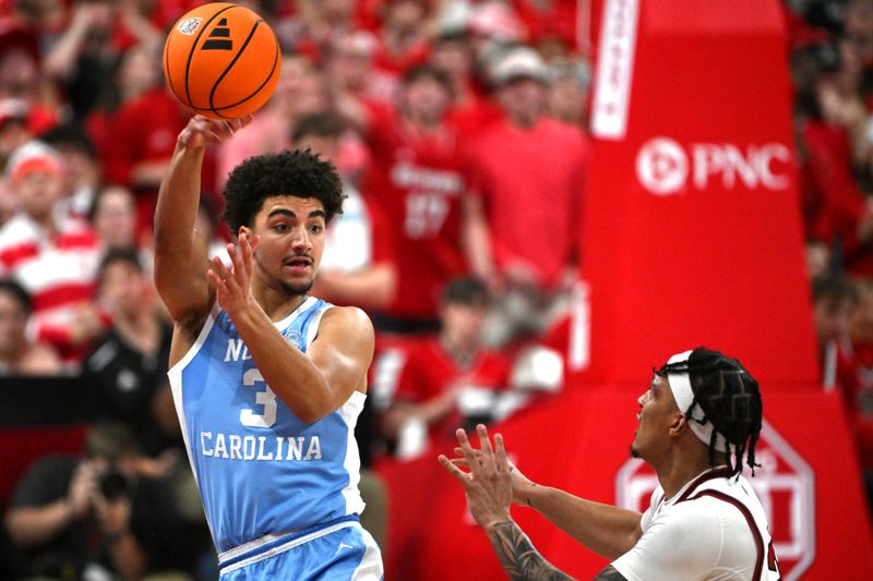 Feb 17, 2026; Raleigh, North Carolina, USA; North Carolina Tar Heels guard Derek Dixon (3) passes the ball at the half court against during the first half against the NC State Wolfpack Lenovo Center. Mandatory Credit: Zachary Taft-Imagn Images