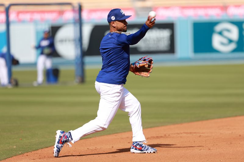 Apr 19, 2024; Los Angeles, California, USA;  Los Angeles Dodgers shortstop Mookie Betts (50) takes a ground ball prior to the game against the New York Mets at Dodger Stadium. Mandatory Credit: Kiyoshi Mio-USA TODAY Sports