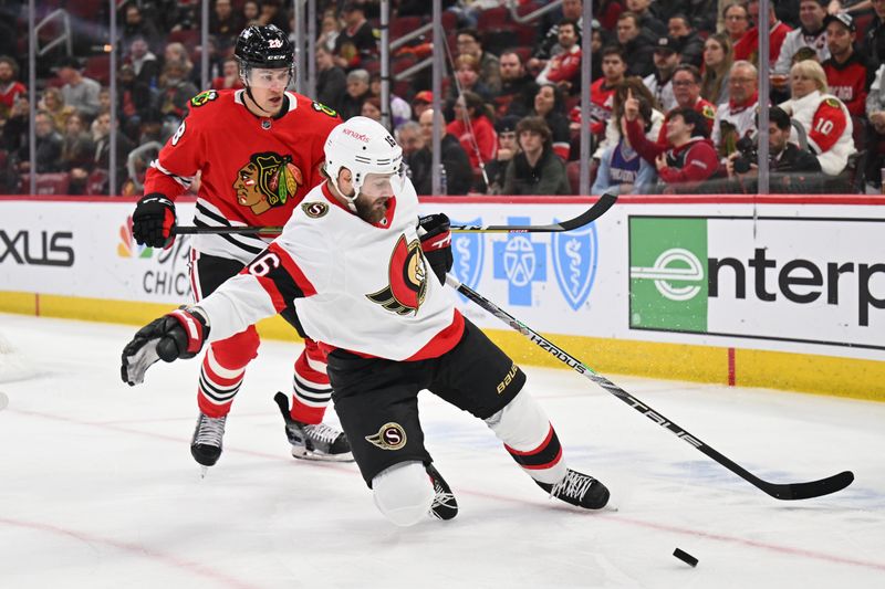 Mar 6, 2023; Chicago, Illinois, USA;  Ottawa Senators forward Austin Watson (16) and Chicago Blackhawks defenseman Andreas Englund (28) battle for control of a loose puck in the first period at United Center. Mandatory Credit: Jamie Sabau-USA TODAY Sports