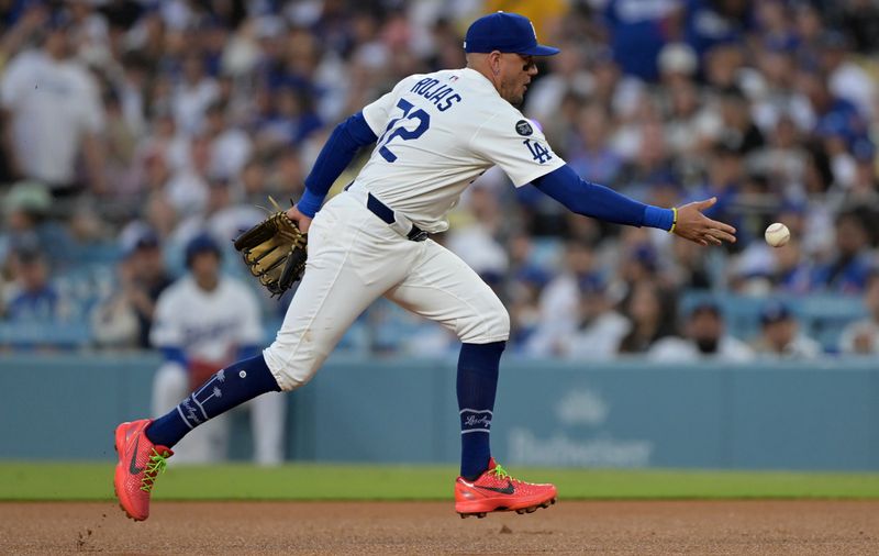 May 21, 2025; Los Angeles, California, USA; Los Angeles Dodgers second baseman Miguel Rojas (72) tosses to first for an out during the third inning against the Arizona Diamondbacks at Dodger Stadium. Mandatory Credit: Jayne Kamin-Oncea-Imagn Images