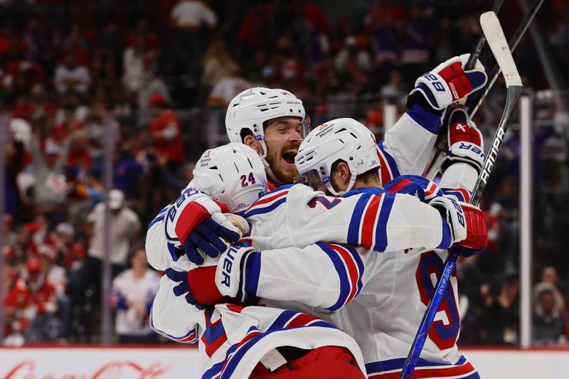 May 26, 2024; Sunrise, Florida, USA; New York Rangers center Alex Wennberg (91) celebrates with center Jack Roslovic (96) and right wing Kaapo Kakko (24) after scoring the game-winning goal in overtime against the Florida Panthers in game three of the Eastern Conference Final of the 2024 Stanley Cup Playoffs at Amerant Bank Arena. Mandatory Credit: Sam Navarro-USA TODAY Sports