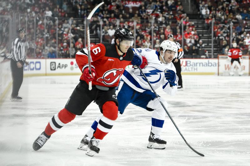 Feb 25, 2024; Newark, New Jersey, USA; New Jersey Devils defenseman John Marino (6) skates against Tampa Bay Lightning center Michael Eyssimont (23) during the second period at Prudential Center. Mandatory Credit: John Jones-USA TODAY Sports