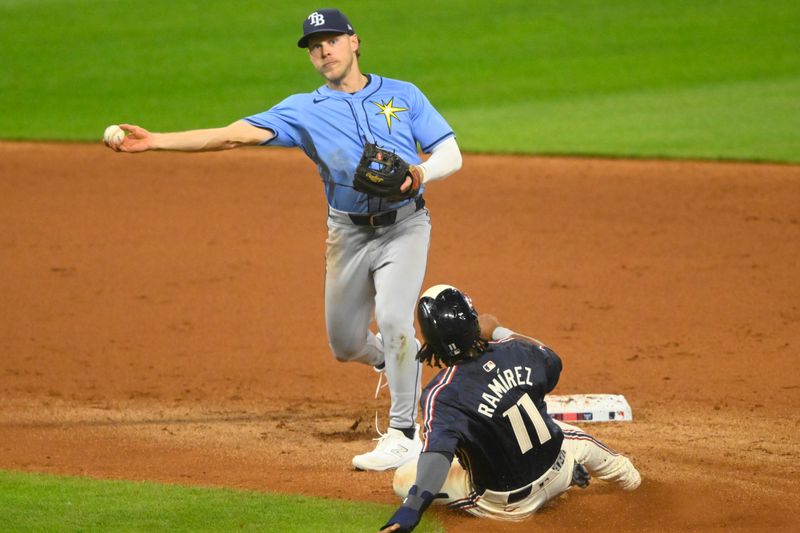 Sep 13, 2024; Cleveland, Ohio, USA; Tampa Bay Rays shortstop Taylor Walls (6) turns a double play beside Cleveland Guardians designated hitter Jose Ramirez (11) in the fourth inning at Progressive Field. Mandatory Credit: David Richard-Imagn Images