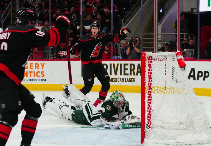 Jan 21, 2024; Raleigh, North Carolina, USA; Carolina Hurricanes center Martin Necas (88) scores a goal past Minnesota Wild goaltender Filip Gustavsson (32) during the first period at PNC Arena. Mandatory Credit: James Guillory-USA TODAY Sports