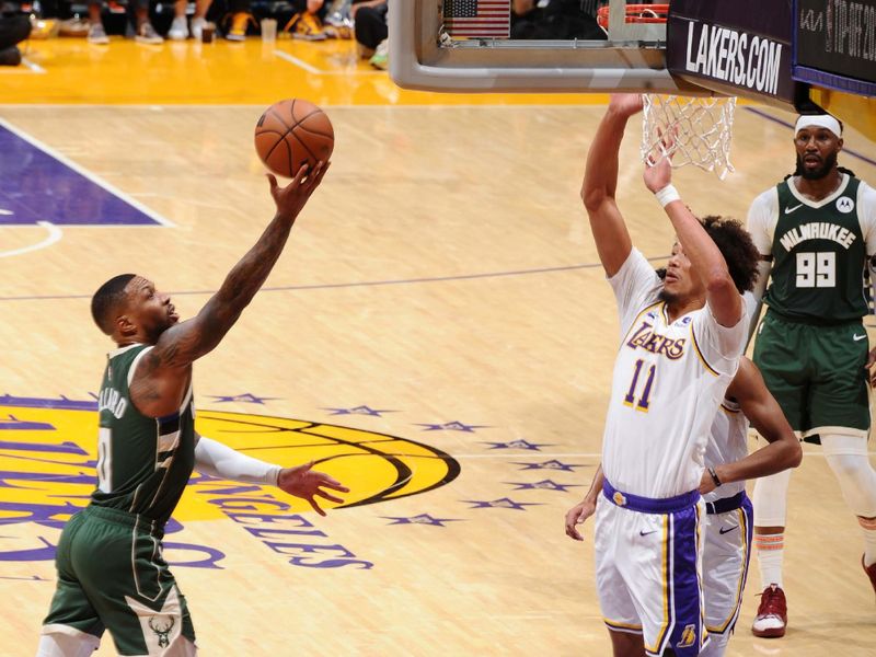 LOS ANGELES, CA - OCTOBER 15: Damian Lillard #0 of the Milwaukee Bucks drives to the basket during the game against the Los Angeles Lakers on October 15, 2023 at Crypto.Com Arena in Los Angeles, California. NOTE TO USER: User expressly acknowledges and agrees that, by downloading and/or using this Photograph, user is consenting to the terms and conditions of the Getty Images License Agreement. Mandatory Copyright Notice: Copyright 2023 NBAE (Photo by Adam Pantozzi/NBAE via Getty Images)