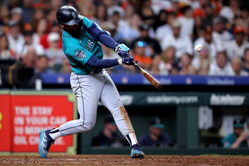 Aug 19, 2023; Houston, Texas, USA; Seattle Mariners designated hitter Teoscar Hernandez (35) hits an RBI double against the Houston Astros during the eighth inning at Minute Maid Park. Mandatory Credit: Erik Williams-USA TODAY Sports