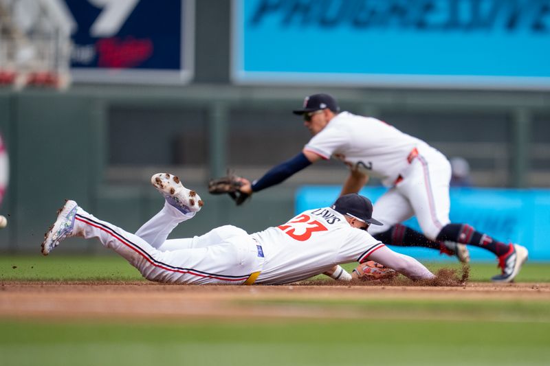 May 24, 2025; Minneapolis, Minnesota, USA; Kansas City Royals right fielder Mark Canha (21) singles on a ball that goes between Minnesota Twins third base Royce Lewis (23) and shortstop Brooks Lee (2) in the second inning at Target Field. Mandatory Credit: Matt Blewett-Imagn Images