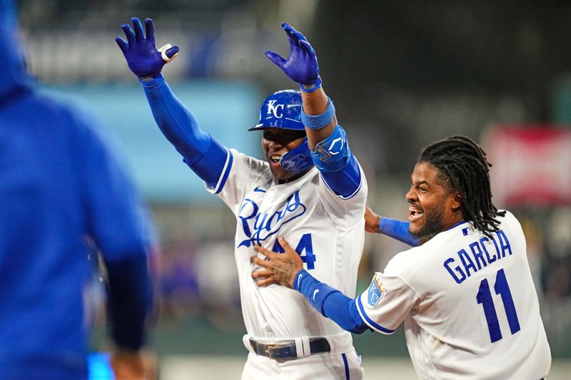 Aug 14, 2023; Kansas City, Missouri, USA; Kansas City Royals left fielder Dairon Blanco (44) celebrates with third baseman Maikel Garcia (11) after hitting a walk-off bunt during the ninth inning against the Seattle Mariners at Kauffman Stadium. Mandatory Credit: Jay Biggerstaff-USA TODAY Sports