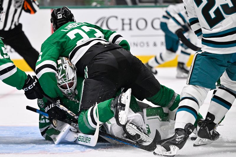 Oct 15, 2024; Dallas, Texas, USA; Dallas Stars defenseman Esa Lindell (23) falls on to goaltender Jake Oettinger (29) during the third period against the San Jose Sharks at the American Airlines Center. Mandatory Credit: Jerome Miron-Imagn Images