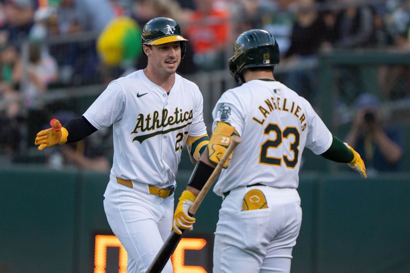 Jul 23, 2024; Oakland, California, USA;  Oakland Athletics outfielder Brent Rooker (25) celebrates with catcher Shea Langeliers (23) during the first inning against the Houston Astros at Oakland-Alameda County Coliseum. Mandatory Credit: Stan Szeto-USA TODAY Sports