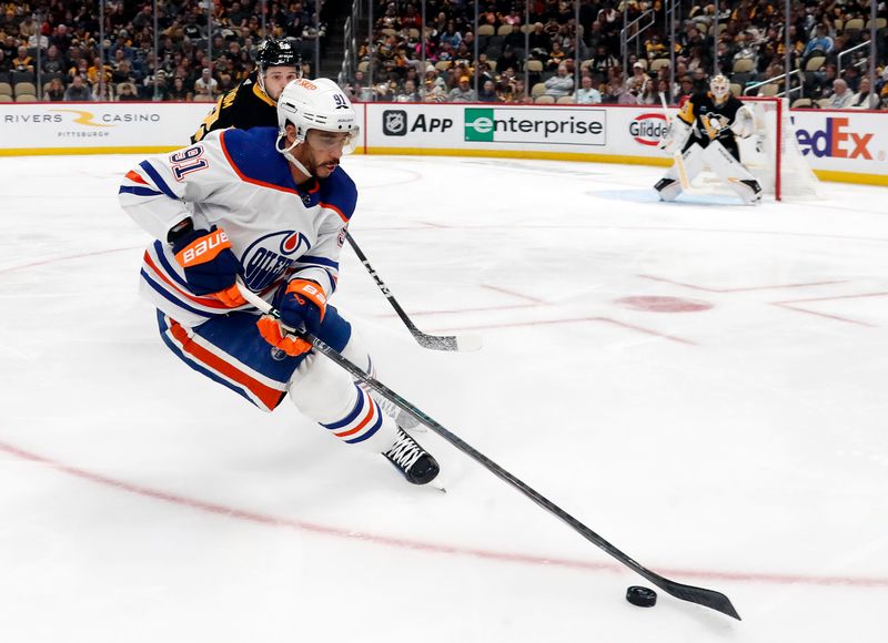 Mar 10, 2024; Pittsburgh, Pennsylvania, USA;  Edmonton Oilers left wing Evander Kane (91) moves the puck against the Pittsburgh Penguins during the second period at PPG Paints Arena. The Oilers won 4-0. Mandatory Credit: Charles LeClaire-USA TODAY Sports