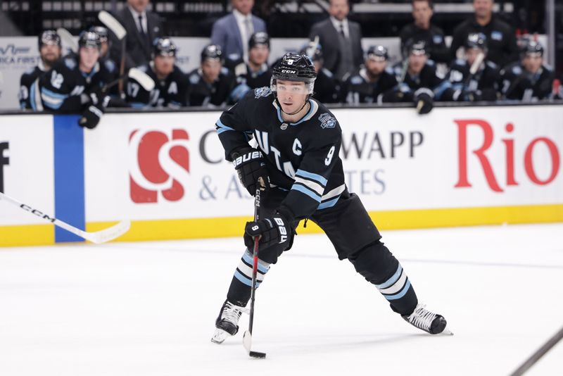 Oct 28, 2024; Salt Lake City, Utah, USA; Utah Hockey Club center Clayton Keller (9) brings the puck up the ice during over-time against the San Jose Sharks at Delta Center. Mandatory Credit: Chris Nicoll-Imagn Images