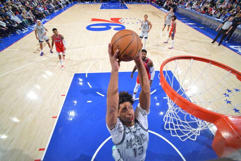 PHILADELPHIA, PA - DECEMBER 6: Jett Howard #13 of the Orlando Magic dunks the ball during the game against the Philadelphia 76ers on December 6, 2024 at the Wells Fargo Center in Philadelphia, Pennsylvania NOTE TO USER: User expressly acknowledges and agrees that, by downloading and/or using this Photograph, user is consenting to the terms and conditions of the Getty Images License Agreement. Mandatory Copyright Notice: Copyright 2024 NBAE (Photo by Jesse D. Garrabrant/NBAE via Getty Images)