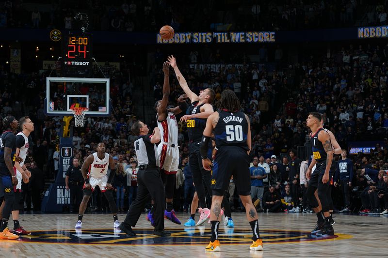 DENVER, CO - FEBRUARY 29: Bam Adebayo #13 of the Miami Heat and Nikola Jokic #15 of the Denver Nuggets go up for the opening tip off on February 29, 2024 at the Ball Arena in Denver, Colorado. NOTE TO USER: User expressly acknowledges and agrees that, by downloading and/or using this Photograph, user is consenting to the terms and conditions of the Getty Images License Agreement. Mandatory Copyright Notice: Copyright 2024 NBAE (Photo by Bart Young/NBAE via Getty Images)