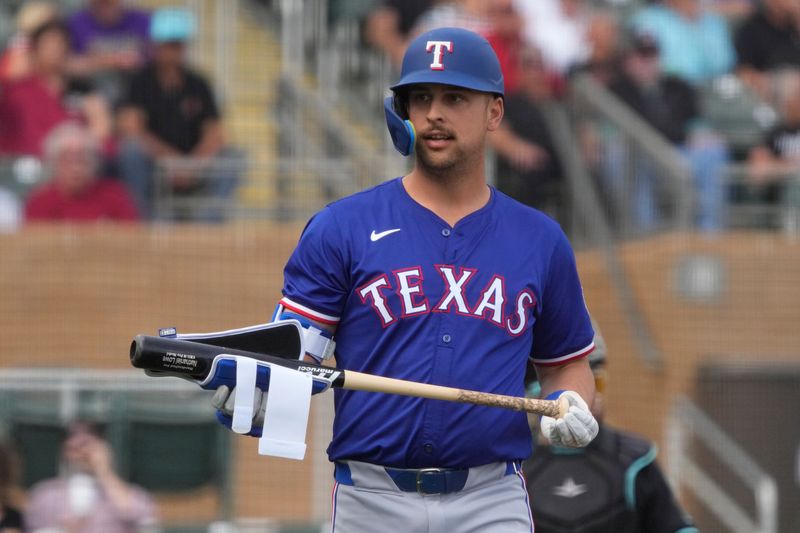 Feb 27, 2024; Salt River Pima-Maricopa, Arizona, USA; Texas Rangers first baseman Nathaniel Lowe (30) reacts after walking against the Arizona Diamondbacks during the first inning at Salt River Fields at Talking Stick. Mandatory Credit: Rick Scuteri-USA TODAY Sports