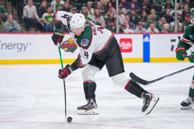 Mar 12, 2024; Saint Paul, Minnesota, USA; Arizona Coyotes defenseman Juuso Valimaki (4) carries the puck against the Minnesota Wild in the second period at Xcel Energy Center. Mandatory Credit: Brad Rempel-USA TODAY Sports