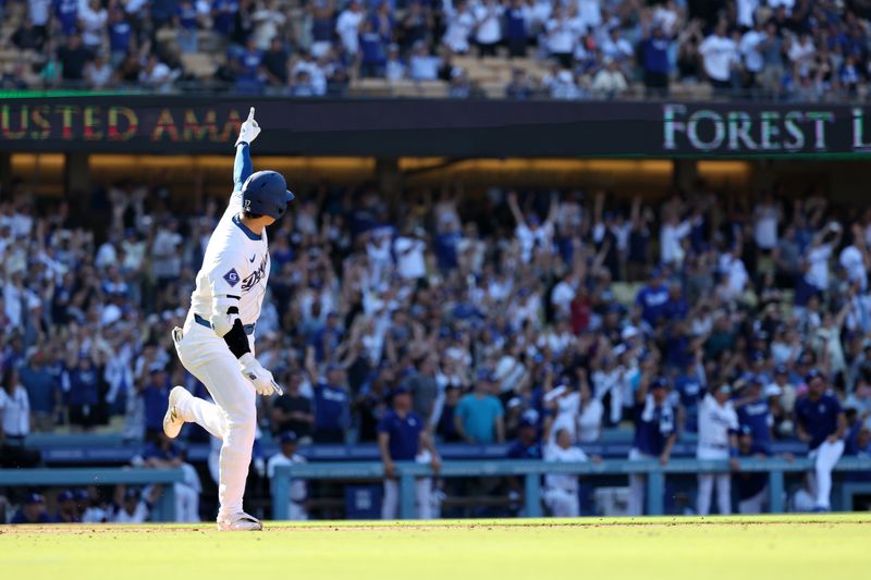 Sep 22, 2024; Los Angeles, California, USA;  Los Angeles Dodgers designated hitter Shohei Ohtani (17) celebrates on a game tying solo home run during the ninth inning against the Colorado Rockies at Dodger Stadium. Mandatory Credit: Kiyoshi Mio-Imagn Images