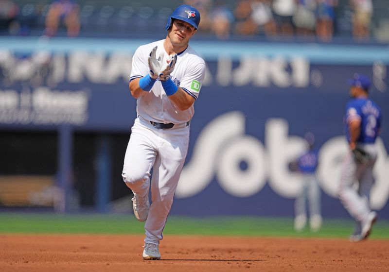 Jul 27, 2024; Toronto, Ontario, CAN; Toronto Blue Jays outfielder Daulton Varsho (25) runs the bases after hitting a three run home run against the Texas Rangers during the first inning at Rogers Centre. Mandatory Credit: Nick Turchiaro-USA TODAY Sports