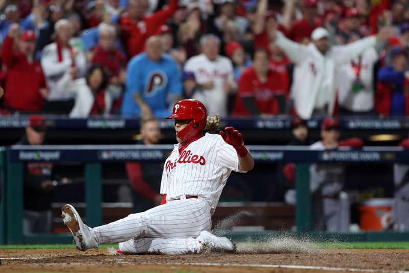 Oct 24, 2023; Philadelphia, Pennsylvania, USA; Philadelphia Phillies first baseman Alec Bohm (28) slides to score against the Arizona Diamondbacks in the fourth inning for game seven of the NLCS for the 2023 MLB playoffs at Citizens Bank Park. Mandatory Credit: Bill Streicher-USA TODAY Sports