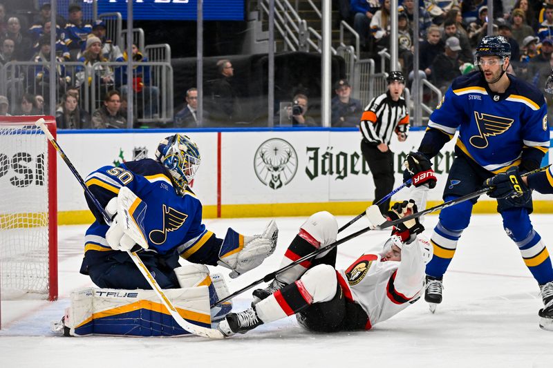 Dec 14, 2023; St. Louis, Missouri, USA;  St. Louis Blues goaltender Jordan Binnington (50) defends the net against Ottawa Senators center Josh Norris (9) during the third period at Enterprise Center. Mandatory Credit: Jeff Curry-USA TODAY Sports