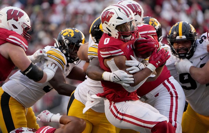 Oct 14, 2023; Madison, Wisconsin, USA; Wisconsin Badgers running back Braelon Allen (0) is stopped at the line by the Iowa Hawkeyes during the third quarter at Camp Randall Stadium. Mandatory Credit: Mark Hoffman-USA TODAY Sports