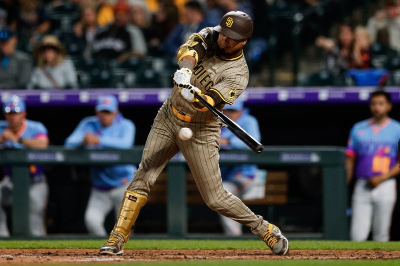 May 9, 2025; Denver, Colorado, USA; San Diego Padres first baseman Luis Arraez (4) hits a single in the sixth inning against the Colorado Rockies at Coors Field. Mandatory Credit: Isaiah J. Downing-Imagn Images