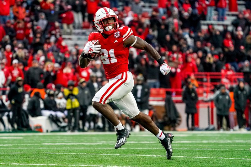 Oct 28, 2023; Lincoln, Nebraska, USA; Nebraska Cornhuskers running back Emmett Johnson (21) runs for a touchdown against the Purdue Boilermakers during the fourth quarter at Memorial Stadium. Mandatory Credit: Dylan Widger-USA TODAY Sports